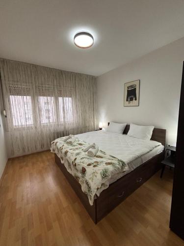 a bedroom with a large bed in a room at Main Square APT with Stone Bridge & Old Bazaar View in Skopje