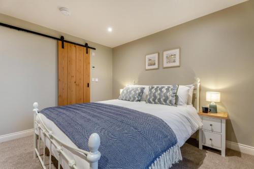 a bedroom with a white bed with a blue blanket at 1 Bed in Castleton oc-t34011 in Castleton