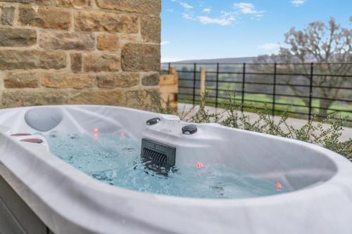 a bath tub with a thermometer in the middle of it at 1 Bed in Castleton oc-t34011 in Castleton