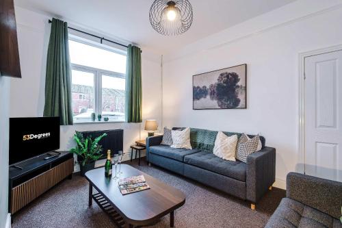 a living room with a couch and a table at Spacious 4 Bed Home in Crewe by 53 Degrees Property! Perfect for Groups & Families in Crewe