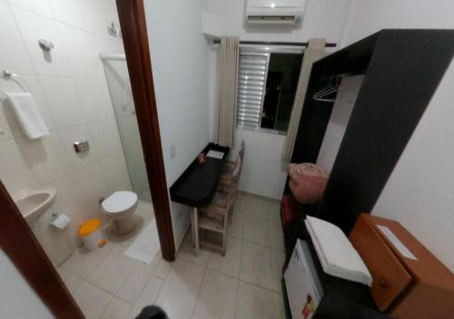 a small bathroom with a toilet and a sink at Villa Maior Hotel in São Roque