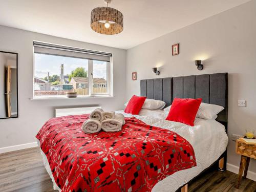 a bedroom with a large bed with red pillows at 3 Bed in Brecon oc-92341 in Brecon