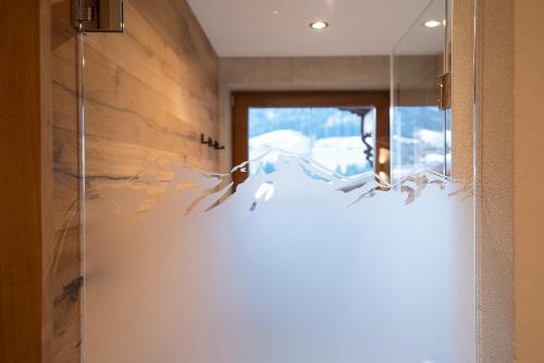 a room with a door with birds on the wall at Der Berghof in Alpbach