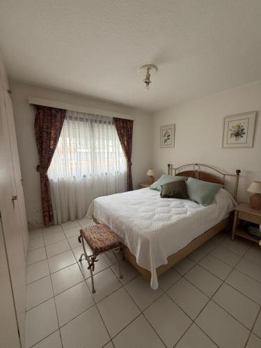 a bedroom with a large bed and a window at Residence Punta del Este 107 in Punta del Este