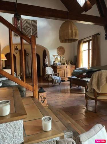 a large living room with wooden floors and aamed ceilings at Chambre d'hôte domainedesthermesgap in La Celle-sous-Gouzon