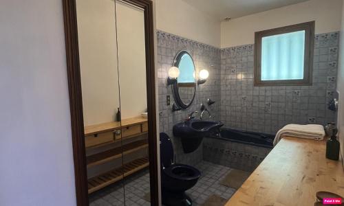 a bathroom with a black toilet and a sink at Chambre d'hôte domainedesthermesgap in La Celle-sous-Gouzon
