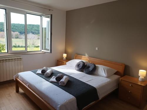 a bedroom with a bed with towels on it at Apartman Blaženka in Kampor