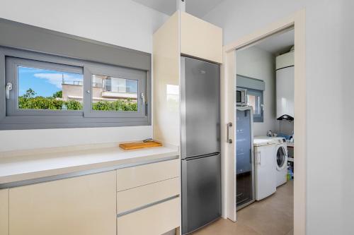 a kitchen with white cabinets and a window at 3110 Villa Malibu in Vistabella