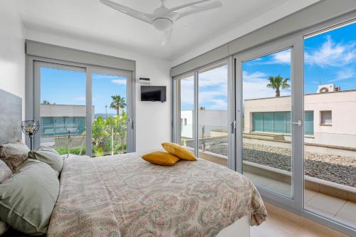 a bedroom with a bed with a view of the ocean at 3110 Villa Malibu in Vistabella