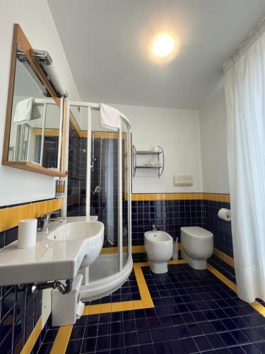 a bathroom with two sinks and two toilets at Hotel Liberty in Pattada