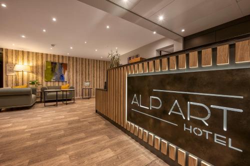 a hotel lobby with a sign that reads al art hotel at Alp Art Hotel Monthey in Collombey