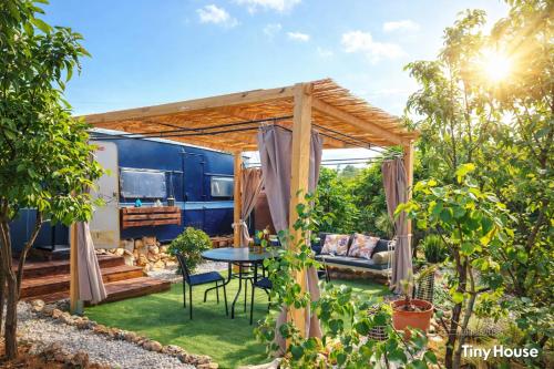an rv backyard with a table and a pergola at dream tiny house & luxury tent in Chania