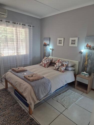 a bedroom with a large bed with pillows on it at Sune's self catering 2 in Worcester