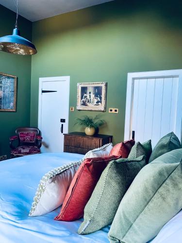 a bedroom with a bed with colorful pillows on it at The Lodge in Kelso