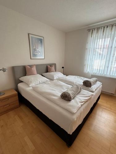 a bedroom with a large bed with two pillows on it at Ferienwohnung zum Utzen in Berching