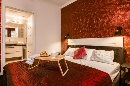a bedroom with a bed with a table on it at Apartament Avignon in Wrocław