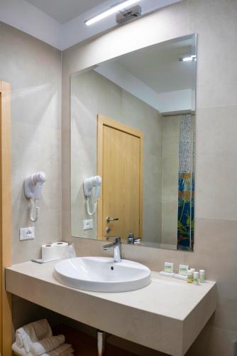 a bathroom with a sink and a large mirror at Villa Athena in Giardini Naxos