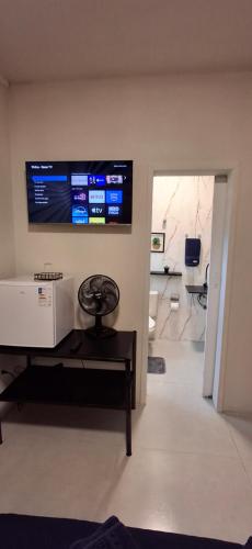 a living room with a flat screen tv on the wall at Vieira's Residencial in Embu