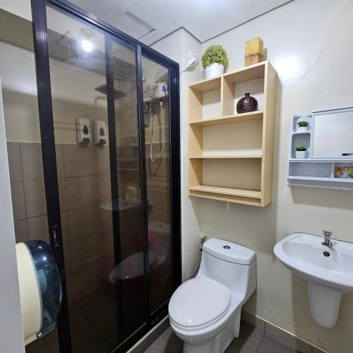 a bathroom with a shower and a toilet and a sink at Avida towers davao condo 6thfloor in Davao City