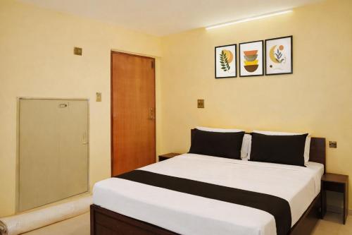 a bedroom with a bed and a sliding glass door at Balaji Inn in Vellore