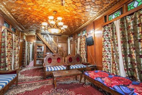 a train room with chairs and a chandelier at White blossom in Srinagar