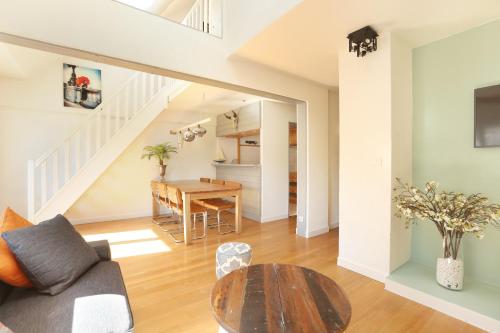 a living room with a table and a dining room at Les Lilas Serviced Apartments in Les Lilas