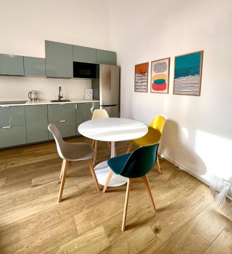 a kitchen with a table and chairs in a room at Andrea's 12 in Bari