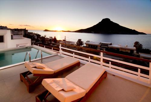 a balcony with a swimming pool and a view of the ocean at Villa Katerina - Between sea & mountain in Kalymnos