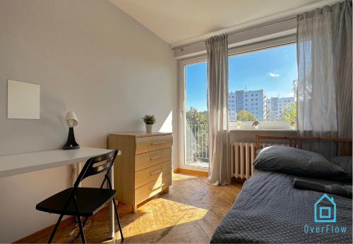 a bedroom with a bed and a desk and a window at Array Room - 5 Minutes to Sopot Molo & Seaside in Sopot
