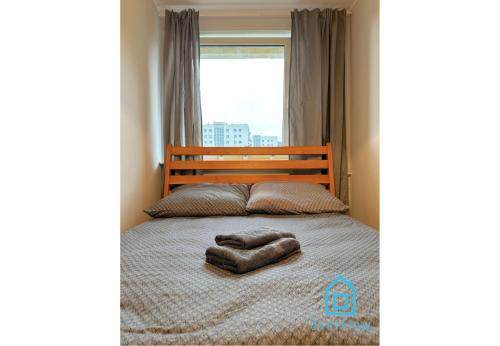 a bedroom with a bed with a large window at Balance Room - 5 Minutes to Sopot Molo & Seaside in Sopot