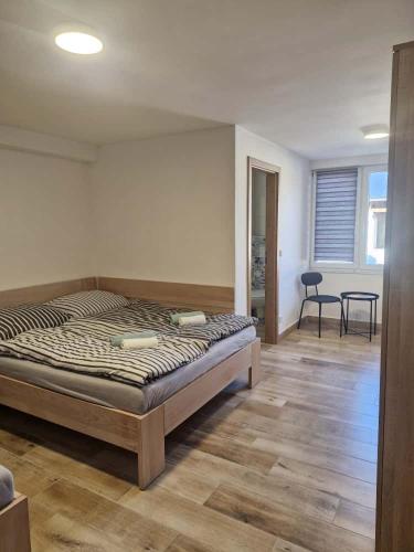 a bedroom with a bed and a table in it at Sklípek u Štýblů in Velké Němčice