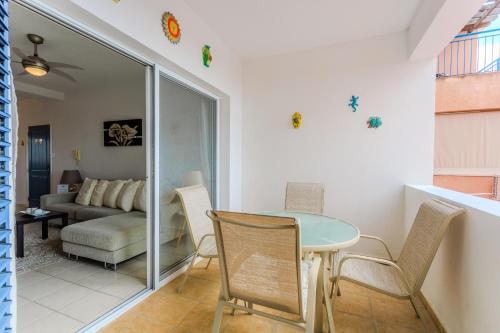 a living room with a table and chairs and a couch at Resitour - Tala Hills in Tala