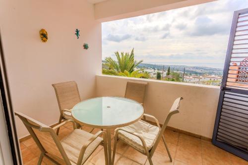 a table and chairs in a room with a large window at Resitour - Tala Hills in Tala