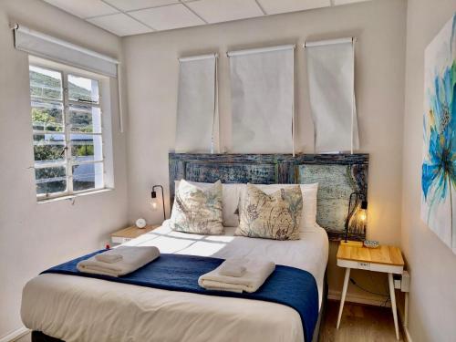 a bedroom with a large bed with two pillows at The Tipsy Expat - Paarl - Self Catering Apartment in Paarl