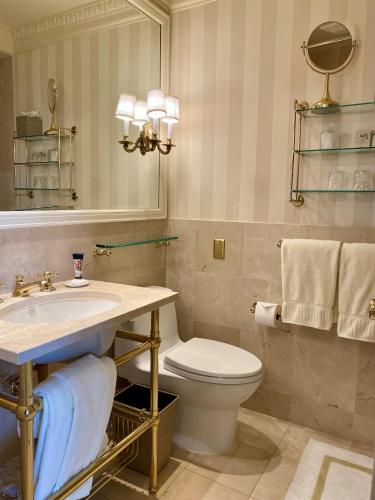 a bathroom with a toilet and a sink and a mirror at The Hay - Adams in Washington, D.C.