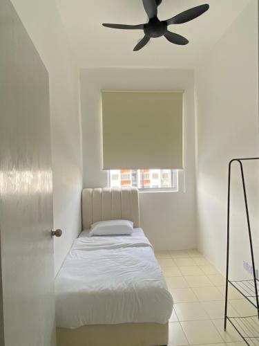 a bedroom with a bed and a ceiling fan at De' Haven Stay - 10minutes to Airport Tawau in Tawau