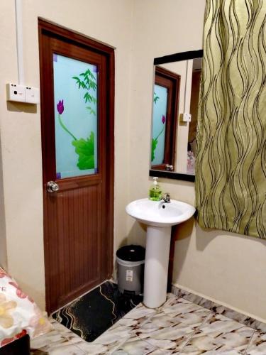 a bathroom with a sink and a mirror at 4F Motel and Homestay by LTS in Pantai Cenang