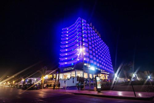 a building with blue lights on it at night at Hotel Servigroup Koral Beach 4 Sup in Oropesa del Mar