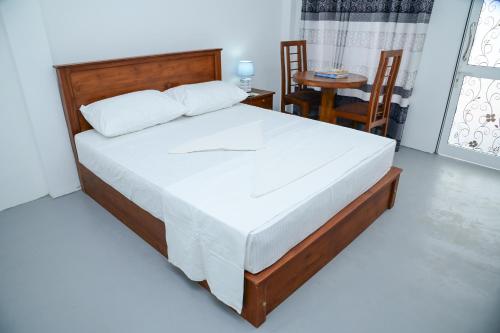 a bedroom with a bed and a table and chairs at Amila Resort - Habarana in Habarana