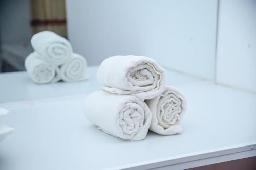 a pile of towels on a counter in a bathroom at Amila Resort - Habarana in Habarana