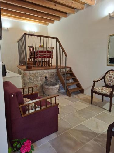 a living room with a staircase and a fireplace at Cecilia Traditional House-Suites in Kalopanayiotis
