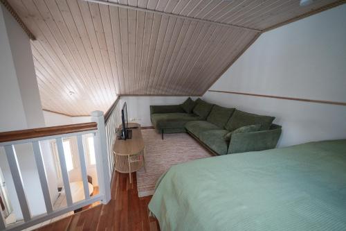 a living room with a couch and a bed at Villa Luoto A Stylish semi-detached house Incl AC, Sauna, Terrace in Kalajoki