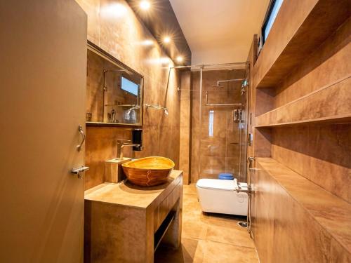 a bathroom with a wooden sink and a tub at Hotel Ambrosia in Gangtok