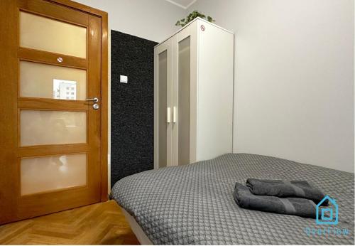 a bedroom with a bed next to a door at Elk Room - 5 Minutes to Sopot Molo & Seaside in Sopot