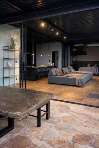a large room with a bed and a table at Loft Vilas Boas in Nova Lima