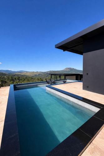 a swimming pool in a house with a view at Loft Vilas Boas in Nova Lima