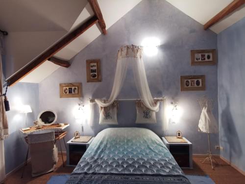 a bedroom with a bed with a canopy at La Mérais in Marsac-sur-Don