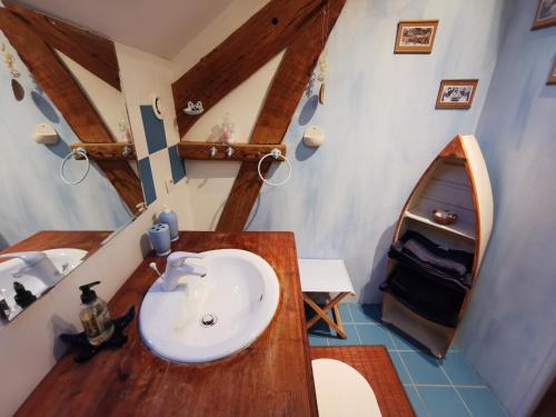 a bathroom with a sink and a mirror at La Mérais in Marsac-sur-Don