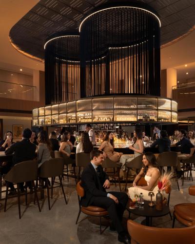 a group of people sitting in a restaurant at Hilton London Metropole in London