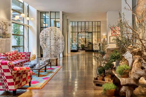 a living room with a couch and a table at Crosby Street Hotel in New York